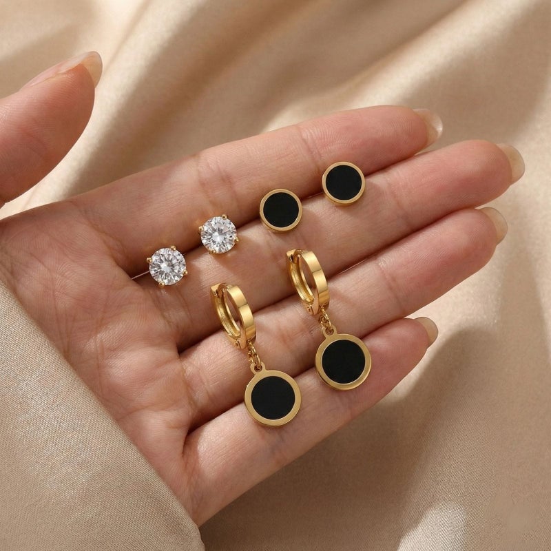 A set of three pairs of exquisite gold earrings: sparkling zircon studs, striking black posts, and luxurious black dangling circles. Crafted from durable stainless steel, a captivating and perfectly harmonious combination. - Image 5